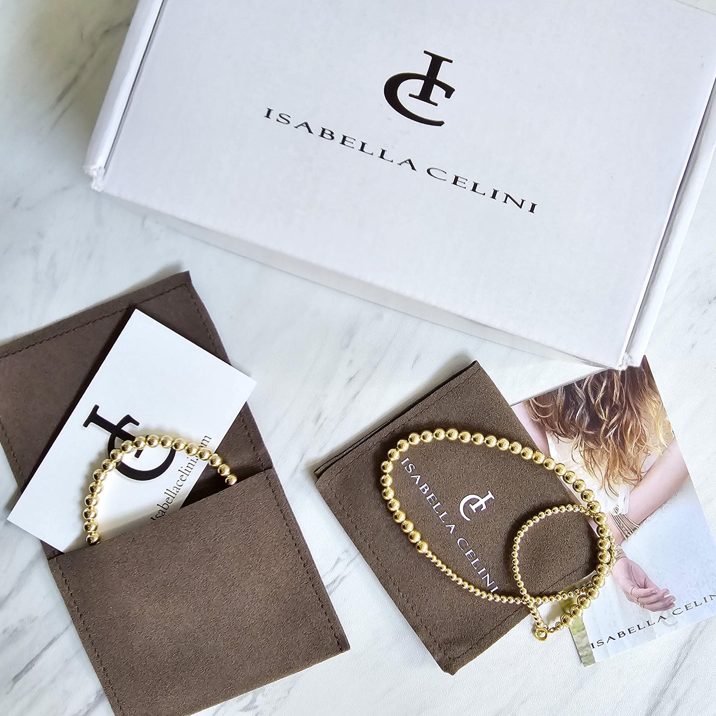 a jewelry box with a bracelet and a card, both with the brand name "Isabella Celini" printed on them.