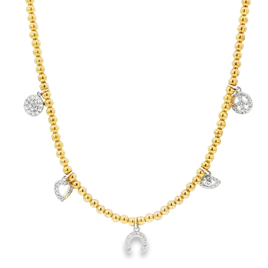 A gold-toned necklace with small charms and gemstones attached to it.