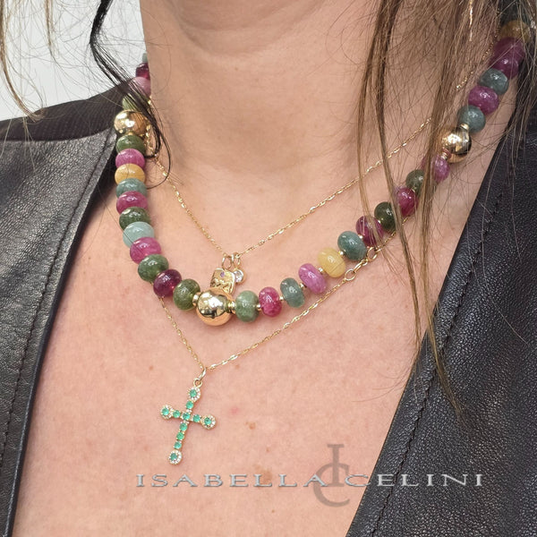 a woman wearing a necklace with a cross on it