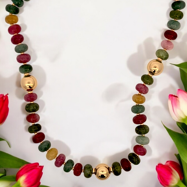 a necklace with various colored stones and flowers