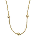 May include: A gold necklace with five round beads. The necklace is made of a delicate chain.