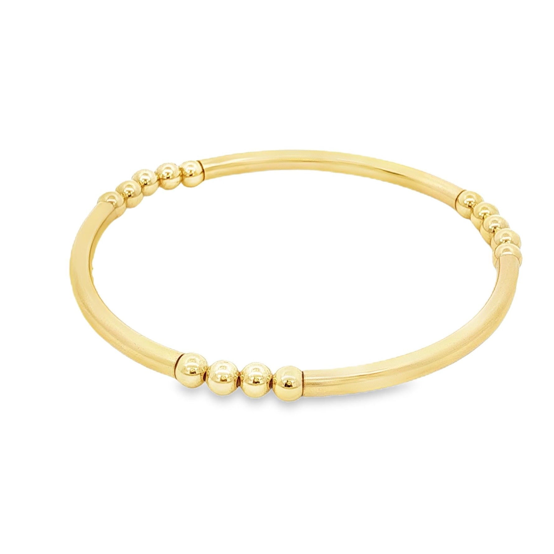 A gold-colored bracelet with a curved design and small round beads on the ends.