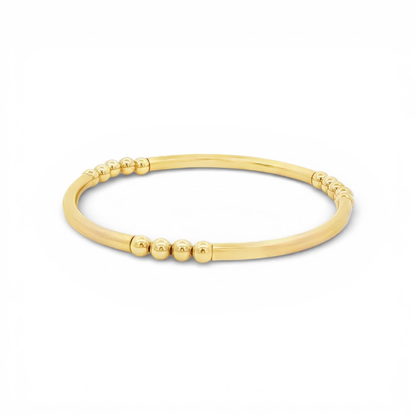A gold-colored bracelet with a curved design and small, round beads along the edge.