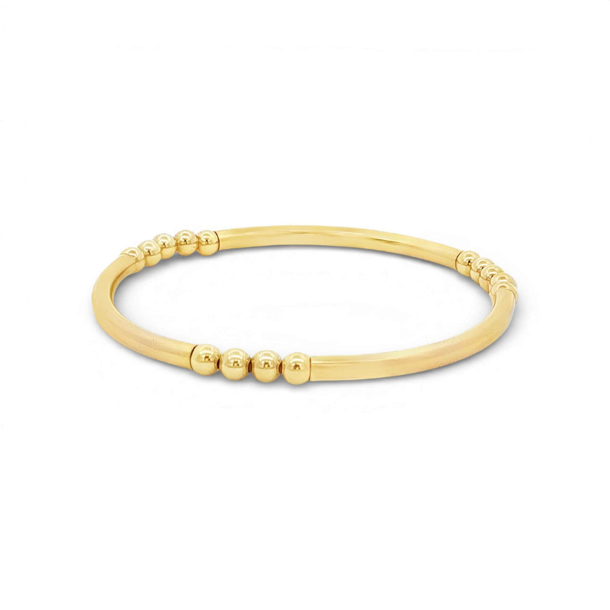 A gold-colored bracelet with a curved design and small, round beads along the edge.